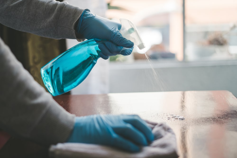 Cleaning,The,Table,With,Disinfectant,Spray,,Bottle,Washing,With,Towels